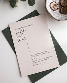 a close up of a wedding card on top of a table with money and flowers