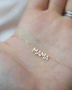 In celebration of all the great mothers around the world, treat the mom in your life to this piece of jewelry they deserve with this gold mama necklace. A perfect way to express what means most to you! Available in 14K yellow, rose or white gold Letters measure about 5mm in height Necklace total length is measured from end to end Dainty minimalist everyday necklace Dainty Everyday Charm Necklaces For Mother's Day, Silver 14k Gold Filled Jewelry For Mother's Day, Gold Jewelry With Hallmark, Yellow Gold Name Necklace, Gift For Mom, Custom Name Necklace In Yellow Gold For Mom, Custom Name Yellow Gold Necklace Gift For Mom, Custom Name Yellow Gold Necklace For Mom, 14k Gold Stamped Charm Necklace For Mother's Day, Personalized Yellow Gold Charm Necklaces For Mother's Day