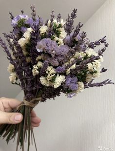 a person holding a bunch of flowers in their hand