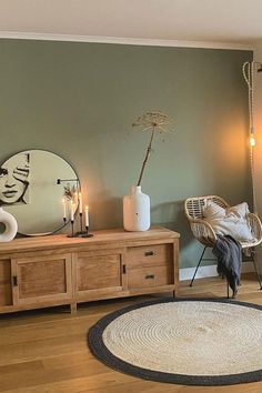 a living room filled with furniture and decor on top of a hard wood flooring