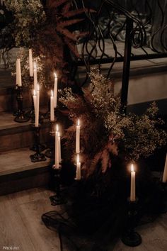 there are many candles that are lit on the stairs