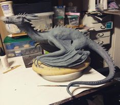 a statue of a dragon sitting on top of a table