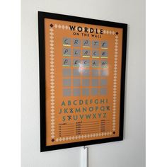 an orange and black poster hanging on the wall