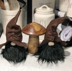 two gnome hats sitting on top of a table next to a clock and other items