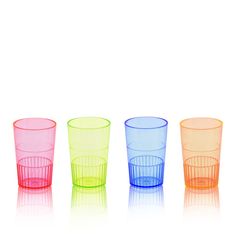 three different colored cups sitting next to each other