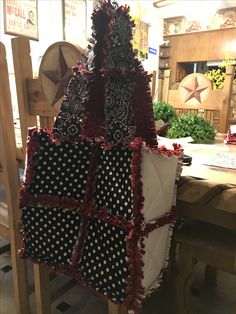 a christmas tree made out of cloths sitting on top of a wooden table