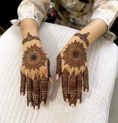 two hands with henna designs on them