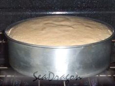 a metal pan sitting on top of an oven with some food in it's bottom