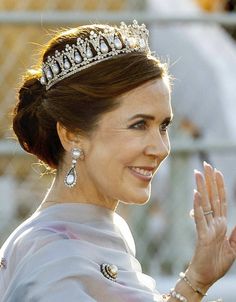 queen letizia of spain waves to the crowd as she arrives for her coronation ceremony