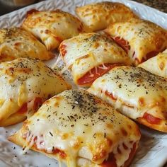 several pieces of pizza on a plate with cheese and tomato sauce, sprinkled with parmesan