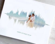 a wedding card with an image of a bride and groom in front of the water