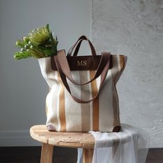 Striped Canvas Tote Bag with Monogram  Enhance your style with this elegant and versatile striped canvas tote bag. Featuring a timeless design with mustard and brown stripes, this tote bag is perfect for every occasion, from a casual day out to a beach trip. The monogram can be any name/initials you like,  adds a personalized touch, making it a unique addition to your accessory collection. Material: High-quality thick fabric with PU leather . Size: Please see picture. Shopping Bag With Striped Lining And Double Handle, Striped Shoulder Bag With Leather Handles For Shopping, Striped Rectangular Bag With Leather Handles, Everyday Striped Bags With Leather Handles, Brown Travel Bag With Striped Lining, Striped Tote Bag With Handles, Striped Shopping Shoulder Bag With Handles, Everyday Bags With Striped Lining And Double Handle, Large Capacity Striped Rectangular Bag