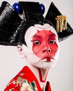 a geisha with black hair and red makeup