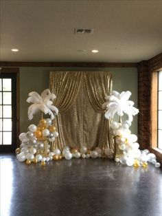 an image of a room with balloons on the floor and curtains in the back ground