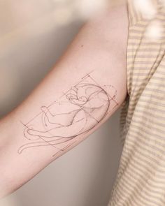 a woman's arm with a drawing on it and the outline of a cat