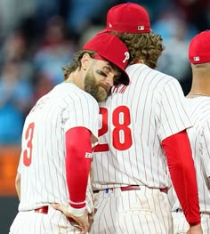 three baseball players standing next to each other