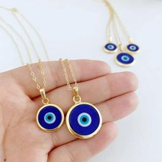 Ward off bad vibes in style with our Blue Turkish Evil Eye Necklace. Perfect for any occasion (except maybe a séance), this necklace features a stunning blue evil eye charm on a delicate chain. Keep the negativity away, all while looking fabulous. This necklace is combination of; - dark blue glass evil eye bead - stainless steel gold chain 15mm Charm Made in Turkey Blue Evil Eye Charm Necklace, Spiritual Blue Evil Eye Jewelry, Blue Pendant Charm Necklaces For Spiritual Style, Blue Evil Eye Jewelry As Gift, Blue Evil Eye Jewelry Gift, Blue Nickel-free Pendant Charm Necklaces, Handmade Blue Round Charm Necklace, Blue Evil Eye Pendant Necklace, Spiritual Blue Charm Necklace With Adjustable Chain