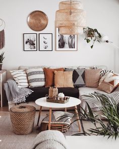 a living room filled with lots of furniture and pictures on the wall above it's coffee table