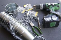 tools are sitting on the floor next to some tin cans and chainmails that have been placed around them