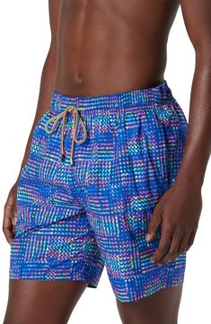 Bright and bold, these printed swim trunks made of lightweight, quick-drying fabric sport a roomy fit and plenty of pockets for essentials. Elastic/drawstring waist Side-seam pockets; back zip pocket with drainage grommets Mesh liner 100% polyester Machine wash, dry flat Imported Blue Sports Swimwear With Pockets, Blue Swim Trunks With Elastic Waistband For Poolside, Blue Nylon Swim Trunks For Sports, Blue Sporty Swim Trunks For Poolside, Blue Nylon Water Sports Shorts, Sporty Multicolor Swim Trunks For Poolside, Blue Nylon Shorts For Water Sports, Sporty Blue Swim Trunks For Pool, Blue Swim Trunks With Side Pockets