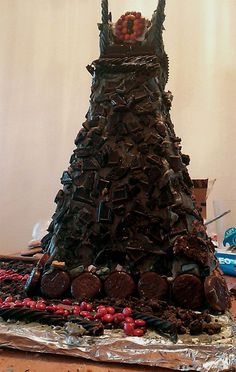 a very large chocolate tower made to look like it's been cut into pieces