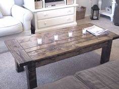 a coffee table with candles on it in a living room