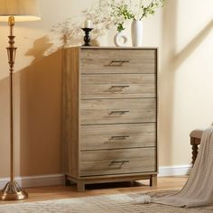 a wooden dresser sitting next to a lamp in a room