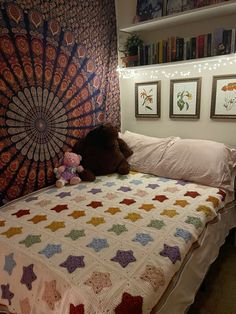 a teddy bear laying on top of a bed in a room with bookshelves