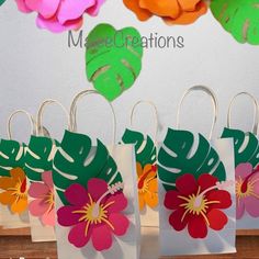 small paper bags with flowers on them hanging from hooks