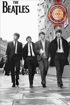 the beatles are walking down the street in their suits and ties, with one man wearing a suit