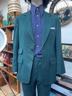 "Outstanding Vintage suit here made by Richman Brothers of pure new wool and viscose,dated Dec 12th 1978. The man that had this made to measure certainly had the 1960s vibe going on,I was quite surprised it was dated so late in the 70's. Perfect Mod Ivy League look to this beauty,has that late 50s early 60s look for me,2 button fastening,flapped pockets,single rear 11\" vent,love the late 60s frog mouth pockets on the strides straight leg and turn ups which can be let down if you so wish,2 rear pockets,1 of which is buttoned,belt loops which gives you room to play with 30-32\" waist,turn up is 1&1/2\" inches plus the same in salvage at the hem. In excellent condition  Measurements as follows are Jacket Shoulder-shoulder 17&1/2\" Shoulder-cuff 24&1/2\" Pit-cuff 17\" Pit-pit 20\" Nape-hem 31 Vintage Single Breasted Fitted Suit, Vintage Fitted Single Breasted Suit, Classic Green Three-piece Suit For Office, Fitted Vintage Single Breasted Suit, Classic Green Three-piece Office Suit, Tailored Retro Tweed Jacket For Business, Retro Tailored Tweed Jacket For Business, Vintage Double Breasted Suit With Notch Lapel For Work, Vintage Double Breasted Suit With Notch Lapel