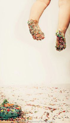 a child's feet are covered with confetti and sprinkles