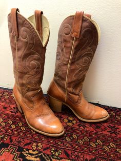 "My first cowboy boots were Acme and I wish I would have kept them- they LAST!  This pair is from the late 70's. They've been well loved and nicely broken in. Uppers have a swirly scroll stitch and are of man made material. The lower part are leather. Heels are wood. The upper shows wear with cracking and bare spots. The foot part shows normal wear too with some minor scuff. Size 5 1/2. Made in USA.  Total height-14\" Heel height-3\" Total length-9.5\" Total width-3.25\"" Scroll Stitch, Carmel Brown, Cowboy Western, Cow Boy, Western Cowboy Boots, Western Cowboy, Western Boots, Boot Shoes Women, Cute Shoes