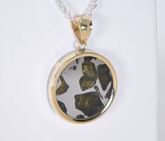 IMILAC PALLASITE METEORITE PENDANT - METEORITE JEWELRY - GOLD On Offer: Beautiful Imilac Pallasite Meteorite Pendant set in 14K Gold. Dimensions not including bail: Approximately 22.75mm x 3.40mm Dimensions including bail: Approximately 33.23mm x 6.34mm Includes an 18" gold chain. Value $450 The majestic Imilac meteorite is arguably one of the most beautiful pallasites ever discovered. The olivine crystals in these pallasite meteorites are among the most prized gemstones in the world. This piece Yellow Gold Jewelry With Natural Inclusions For Anniversary, Anniversary Pendant Jewelry With Natural Inclusions, Meteorite Jewelry, Meteorite Pendant, Gold Top, Bellows, Pendant Set, Pocket Watch, Gold Chain