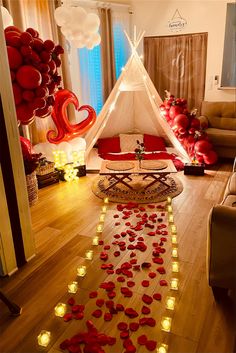 a room decorated with red balloons and lights