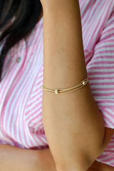 Channel a sophisticated energy with ease when you wear the Aubrey Gold Layered Bracelet! This bracelet is made of gold ball chains. Wear it on its own or stacked with other bracelets, either way you'll love it! Gold Plated Ball Chains One Size | Diameter 2.5” Adjustable Gold Minimalist Wrap Bracelet, Adjustable Gold Bracelet For Layering, Gold Stackable Bracelets For Friendship, Gold Everyday Bracelets, Adjustable Gold Stretch Bracelet With Extender, Adjustable Gold Stretch Bracelet For Everyday, Gold Stretch Bracelet For Everyday Wear, Everyday Gold Stretch Bracelet, Adjustable Gold Wrap Bracelet For Everyday