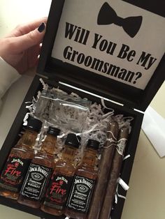 a person is holding an open box with three bottles in it and the words will you be my groomsman?