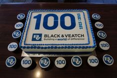 a birthday cake with the words 100 on it and blue icing around the edges