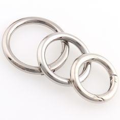 three metal rings on a white background