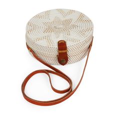 Our round Bali rattan crossbody shoulder basket bag roomy enough to put your, sunglasses, lipstick, cell phone and coin purse. A perfect Summer handbag, easy to pack for travel to a resort, beach or cruise. (PRODUCT INFO): Size: 8" H x 8.5" W x 3" D/ 20cm x 21.5cm x 8cm Strap drop: 24" inches/60cm Material: Rattan Lining: Batik print cotton Leather strap Leather snap closure (SHIPPING INFO): All our items are made-to-order, therefore please allow 3-5 business days for production. Our goal is to White Straw Bucket Bag For Travel, White Straw Crossbody Bag For Summer, White Open Weave Travel Bag, White Basket Bucket Bag For Travel, Adjustable Crossbody Shoulder Bag For Vacation, Summer White Crossbody Straw Bag, White Open Weave Shoulder Bag For Travel, Summer Portable Crossbody Straw Bag, White Open Weave Beach Bag For Travel