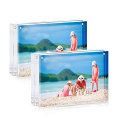 two clear acrylic frames with people playing in the sand