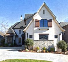 a large white house with lots of windows and shutters