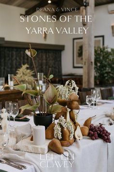 the table is set with white linens and place settings