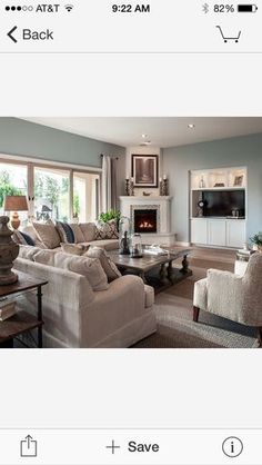 a living room filled with furniture and a fire place in the middle of a room