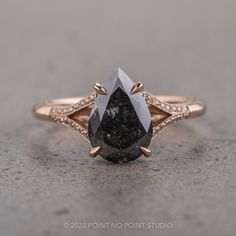 a black diamond ring with white diamonds on it