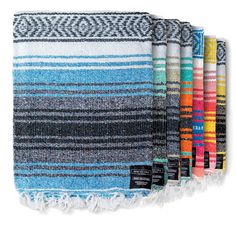 multicolored striped towel with fringes on the bottom and one folded in different colors