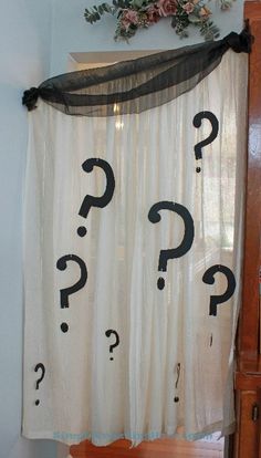 a curtain with question marks drawn on it