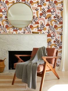 a chair with a blanket on it in front of a fire place and wallpaper