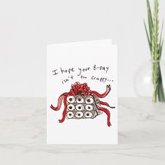 a greeting card with an octopus holding a gift box and saying i hope you're - day isn't the gravity