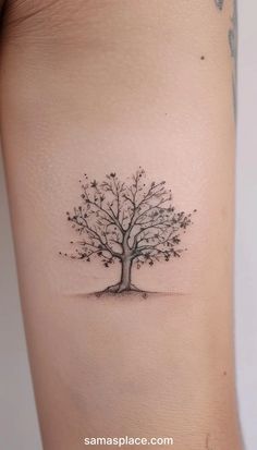 a small tree tattoo on the arm